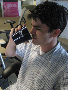 Staff photographer Erik Jepsen drinks out of a Calit2 coffee mug