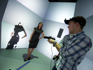 Daniel Tenedorio in the middle of making a freehand 3D scan of Tiffany Fox in Calit2’s StarCAVE using a modified Kinect