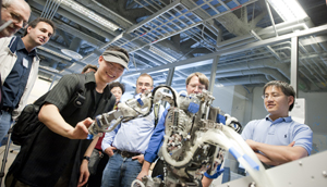 Members of the NSF review board watch a demo of a robot at the MP Lab