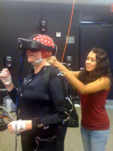 A camp scene from TDLC's Motion Capture/Brain Dynamics Facility, in the San Diego Supercomputer Center.(L-R) Natasha Avis, UC Santa Barbara (in the body suit); and Angelica Rodriguez, a post-baccalaureate researcher in UC San Diego’s Machine Perception Lab, which is housed at Calit2. 