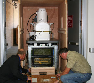Zeiss employees prepare to unload the EVO multipurpose scanning electron microscope at Calit2 Irvine.