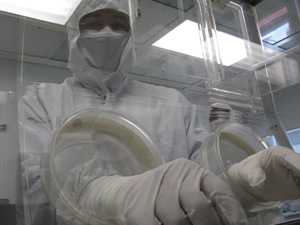 A researcger in the Nano3 lab loads a sample into a relative ion etcher. Nano3 provides essential nanofabrication capabilities for research on electronic and optoelectronic materials and devices, as well as biomedical and biochemical devices, heterogenous integrated devices and circuits, and sensor technology.