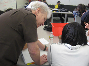Ilan Sampson helps a student at San Diego's High Tech High School use the QAMA to estimate the answer to a math problem.