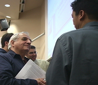 Industry mentor talks with ECE 191 students about their research poster