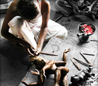 An artisan in Tamil Nadu, India, creates a bronze deity.