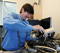 Calit2 researcher Doug Palmer is frustrated by the many external "wall warts" he has to use to power