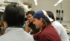 Javier Rodriguez Molina (center, in hat) advises students on their Engineering Group Design Project.