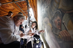 Maurizio Seracini (foreground) and his team view footage captured by the endoscope behind the Vasari wall