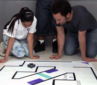 With the assistance of Machine Perception Lab researcher Paul Ruvulo (at right), a RFT student attem