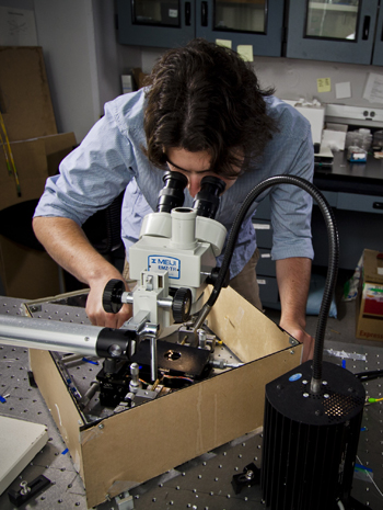 Maurice Ayache looking into a microscope