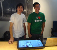 UCSD PRIME students, Lance Castillo and Wesley Hsu, show off the touch screen interface display.
