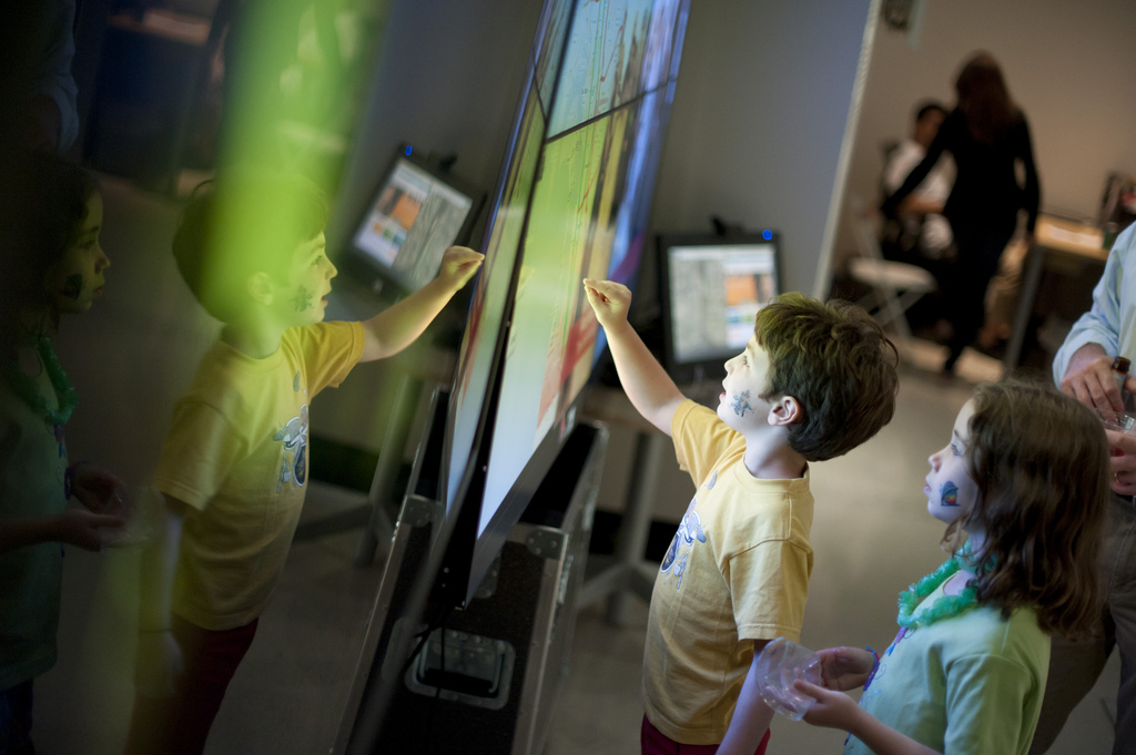 Children interact with the OptIPortable at the Knowledge Exchange Corridors exhibition at the gallery@calit2.