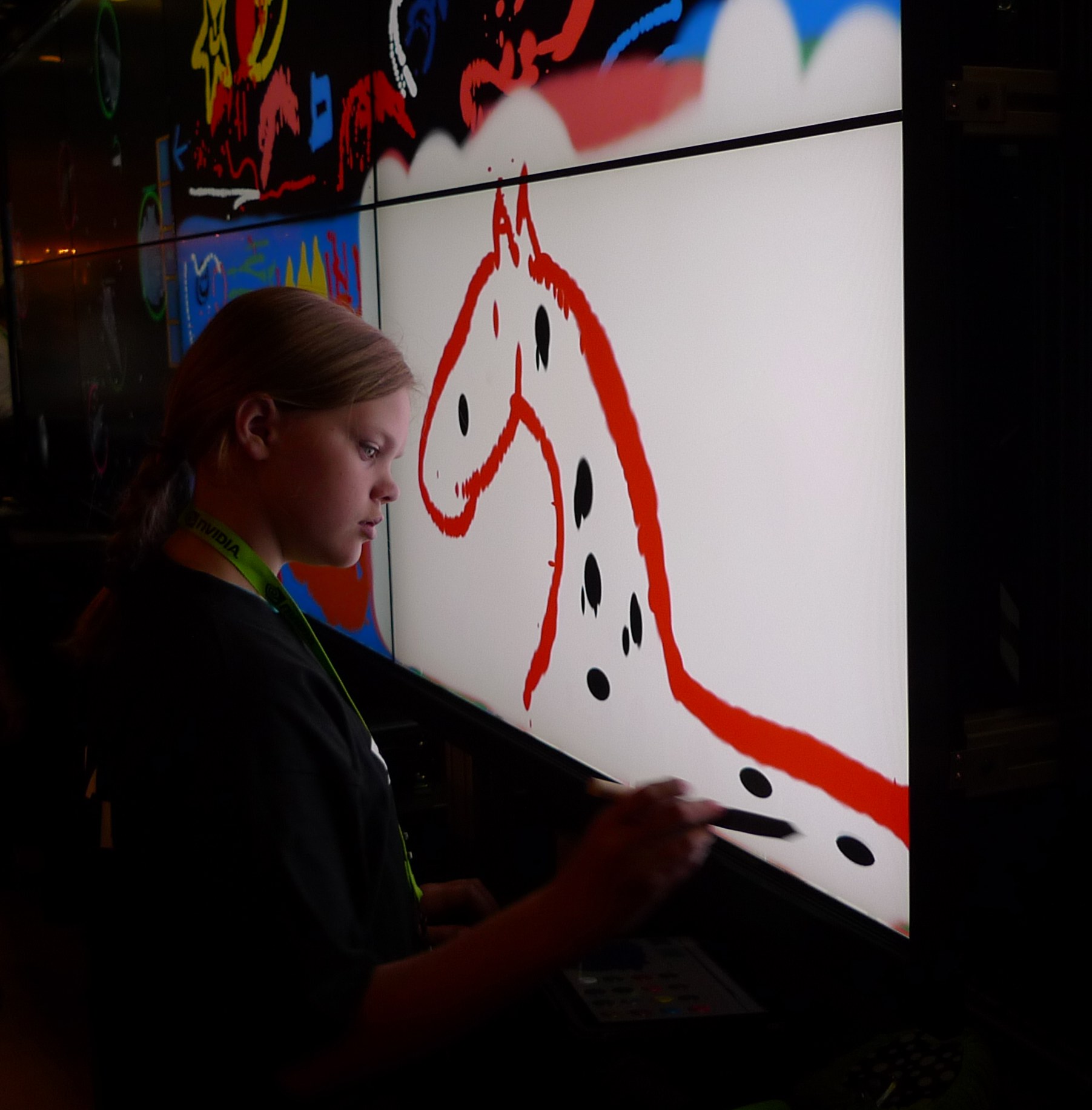 A young girl interacts with the Vroom's touchscreen and EVL's Paint Program