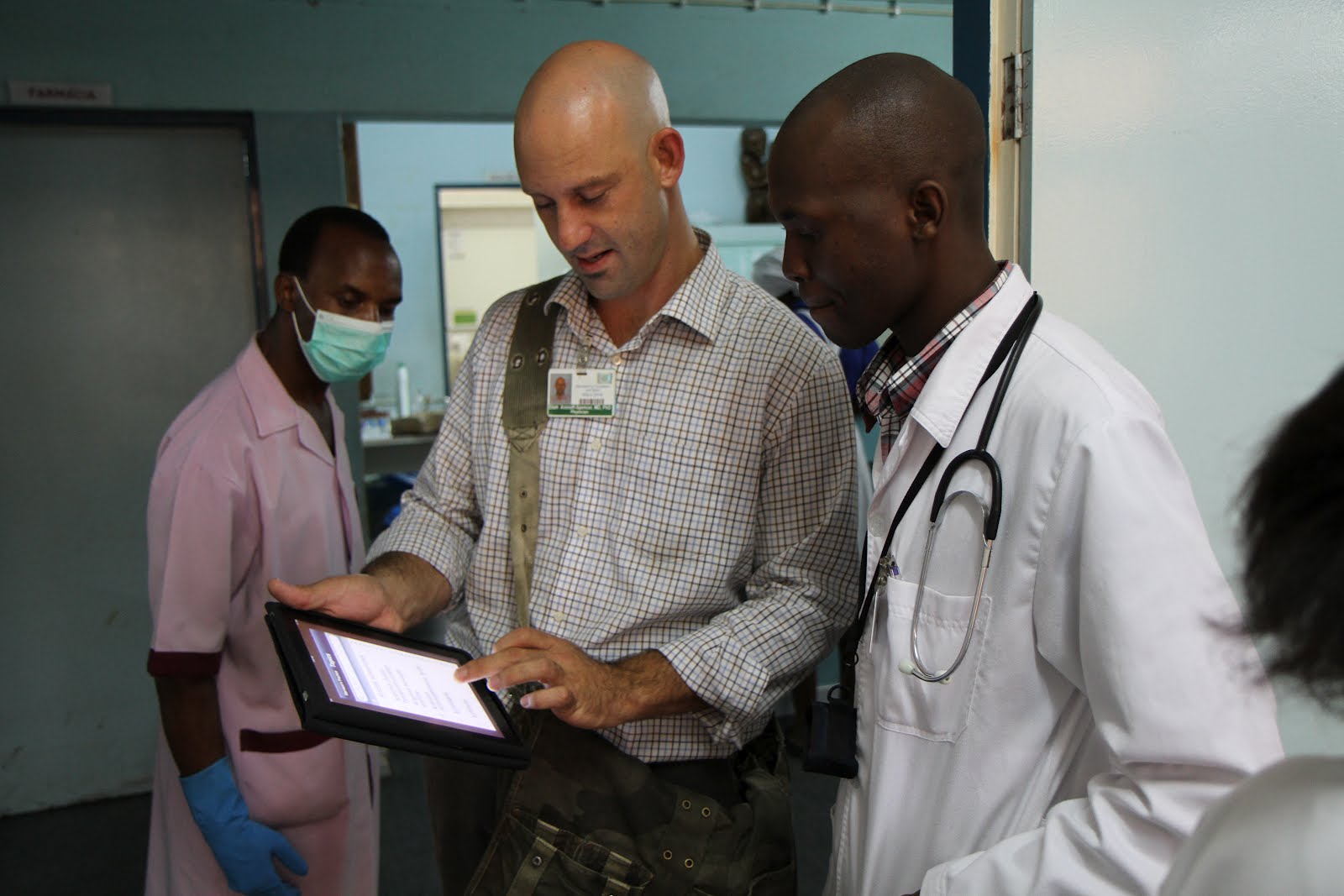 Dr. Eliah Aronoff-Spencer discusses new DH Lab-developed technologies with a doctor at Mozambique's Universidade Eduardo Mondlane