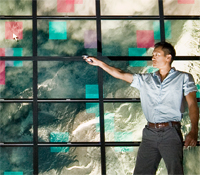 Albert Lin in front of a satellite image of Mongolia on the Calit2 HIPerSpace visualization wall at 