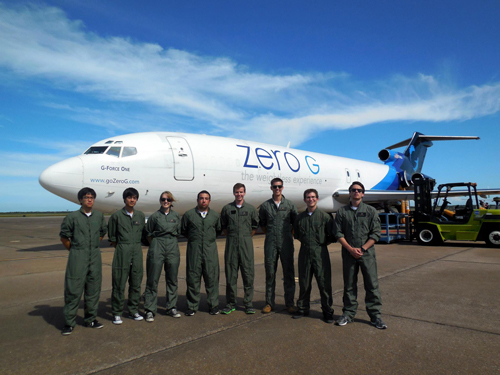 The UC San Diego Microgravity team poses in front of the special NASA plane they used for their experiments on biofuels in space.