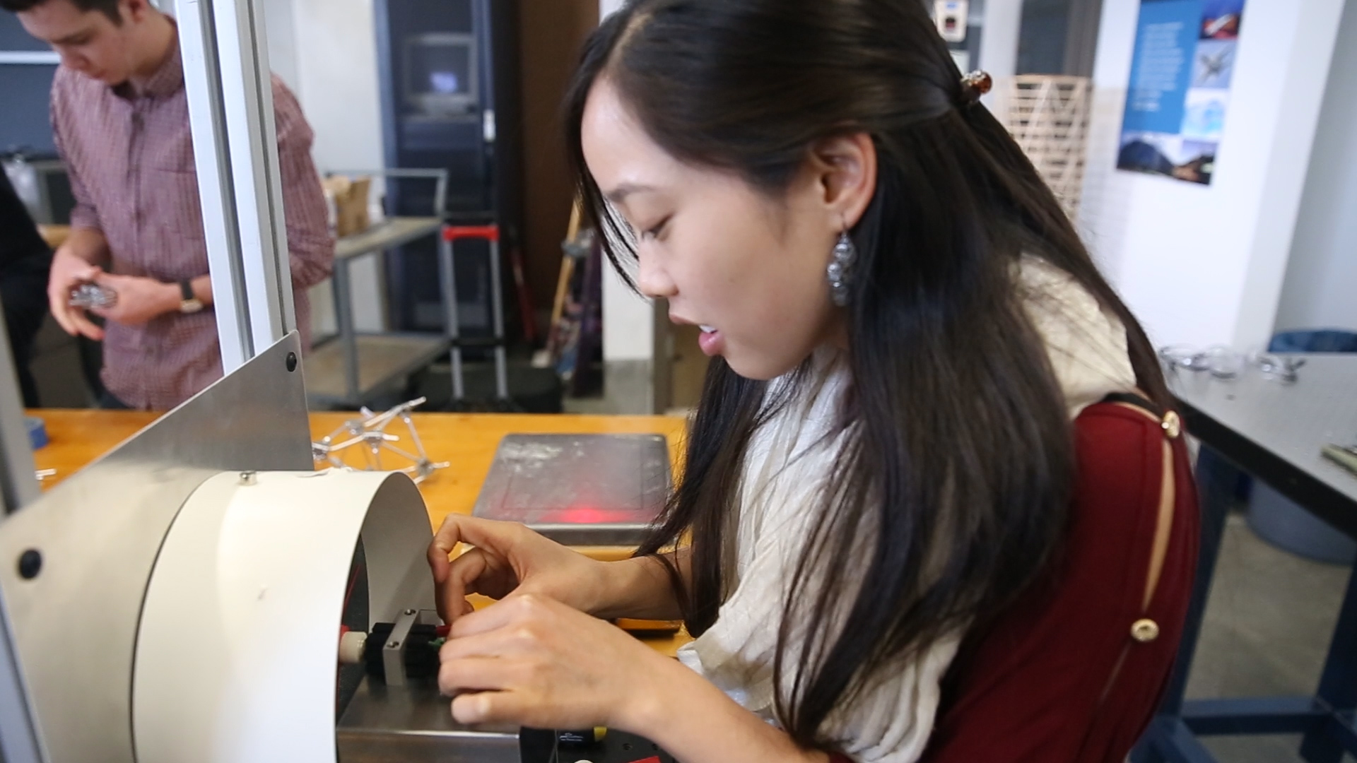 A student places a blade on a turbine