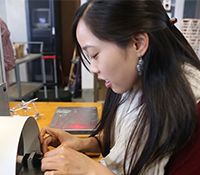 A student places a blade on a turbine
