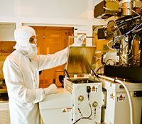 Ryan Anderson, process engineer for the Nano3 facility in the Qualcomm Institute, prepares to remove