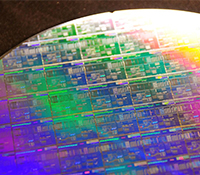 Wafer-scale fabrication of photonic devices is enabled by silicon foundry manufacturing, lowering th