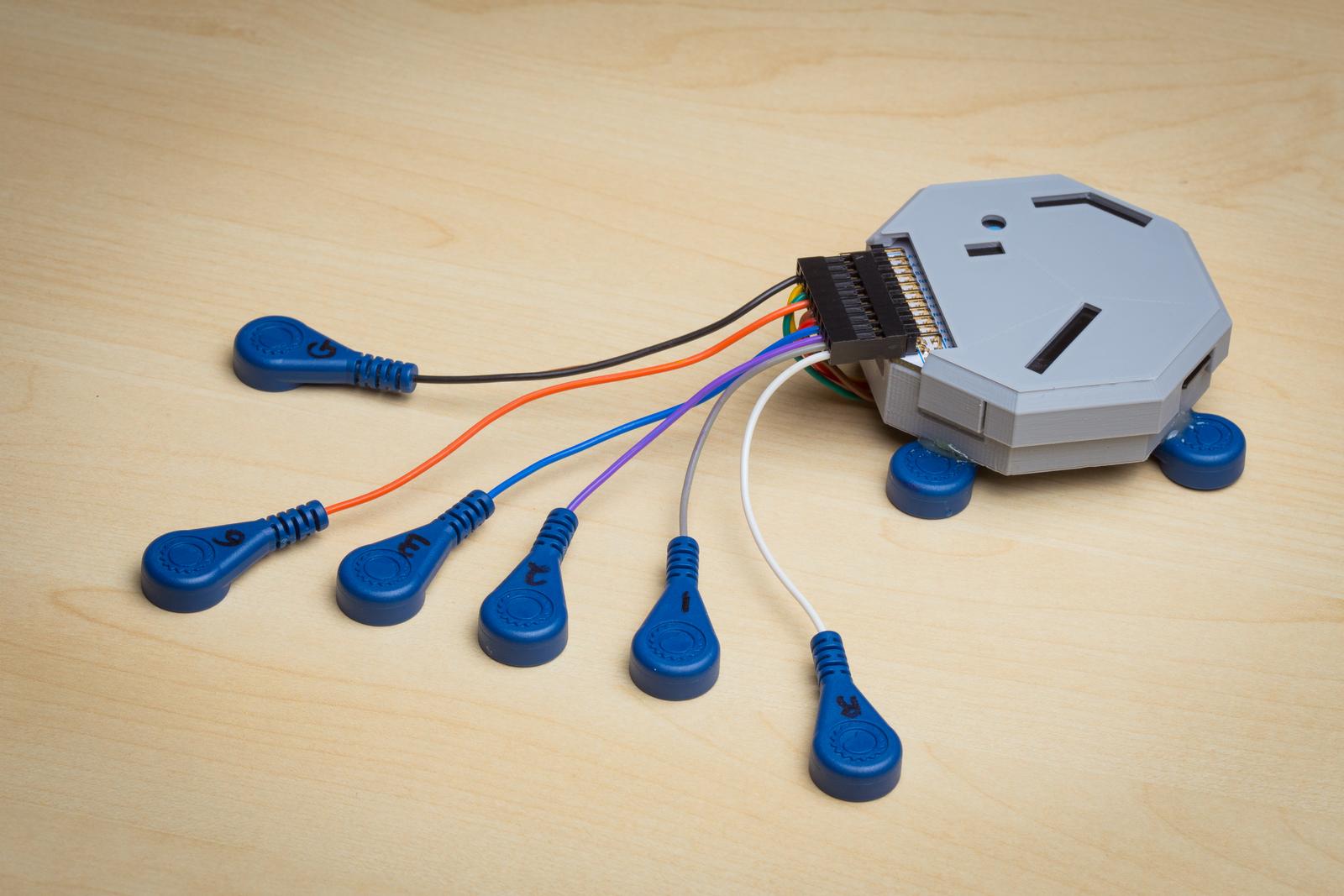 The system is made up of a custom circuit board, a battery and off-the-shelf electrodes.