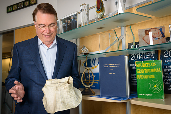 Calit2 director Larry Smarr with physical model of two black holes colliding to produce gravitationa