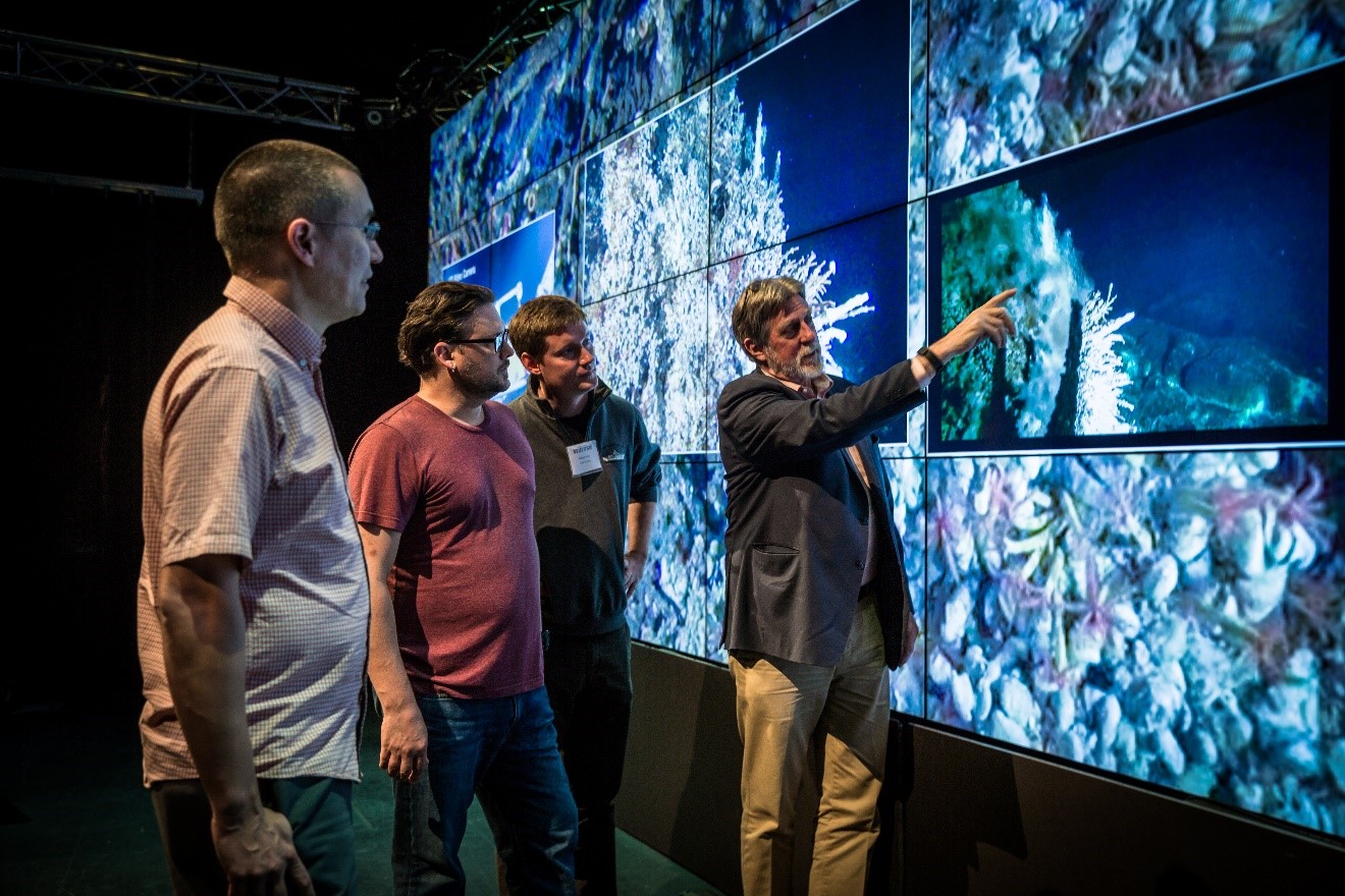 John Delaney points out an actively venting feature to his three colleagues who were central to the delivery of the CAMHD demonstration.  From the left, are: Aaron Marburg, Tim Crone, and Friedrich Knuth. 