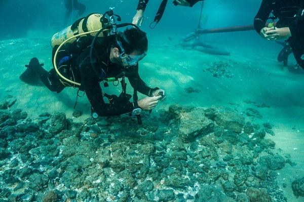 A scuba diver finds ceramic shard
