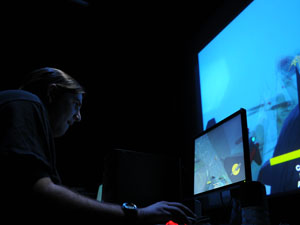 An audience member plays Team Leviathan's "20,000 Frags Under the Sea"